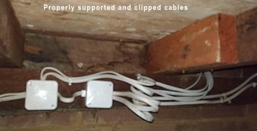 Properly clipped cables under a floor